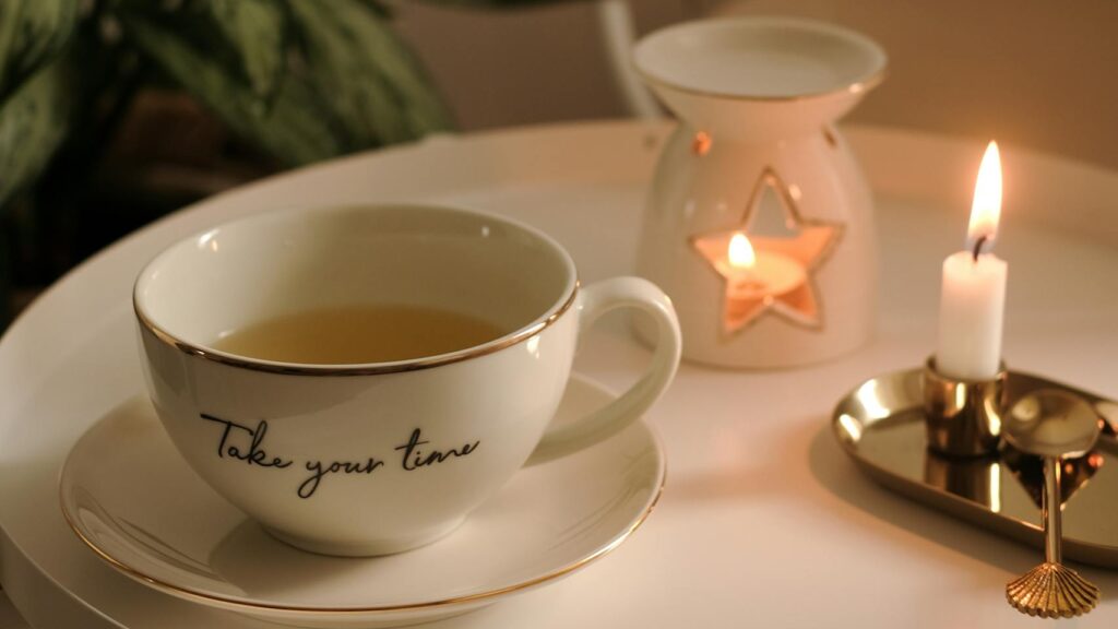 Comforting tea scene with candlelight, symbolizing natural rituals that include magnesium for anxiety and sleep.