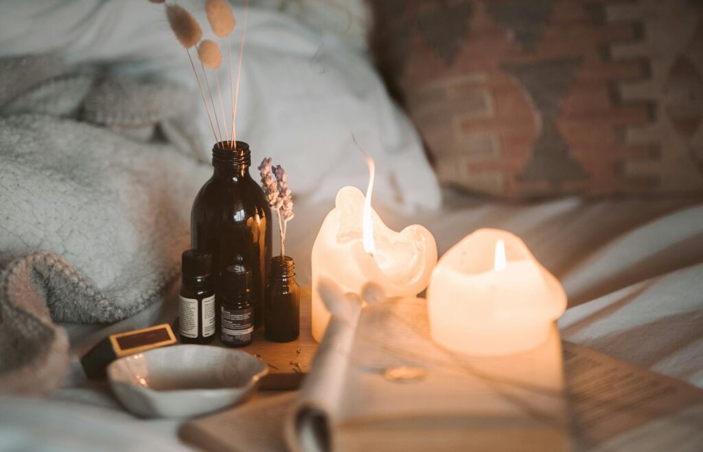 Natural sleep aids like lavender oil, candle, and book showing how to get deep sleep naturally.