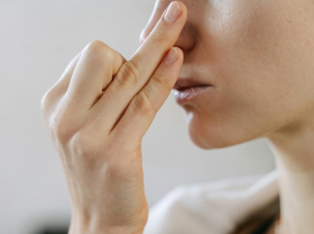 Woman practicing alternate nostril breathing for nervous system balance.