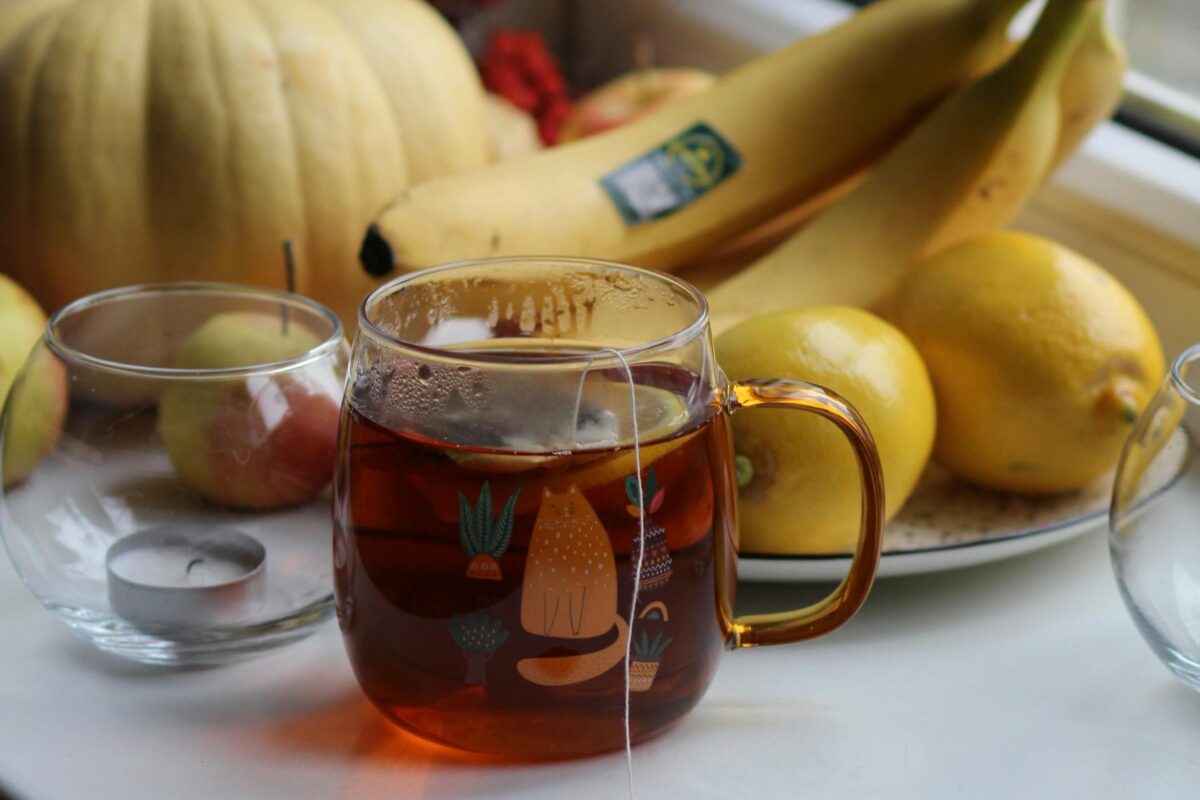 Soft morning light with warm cup of tea with bananas and lemons— calming minerals for mood and energy.