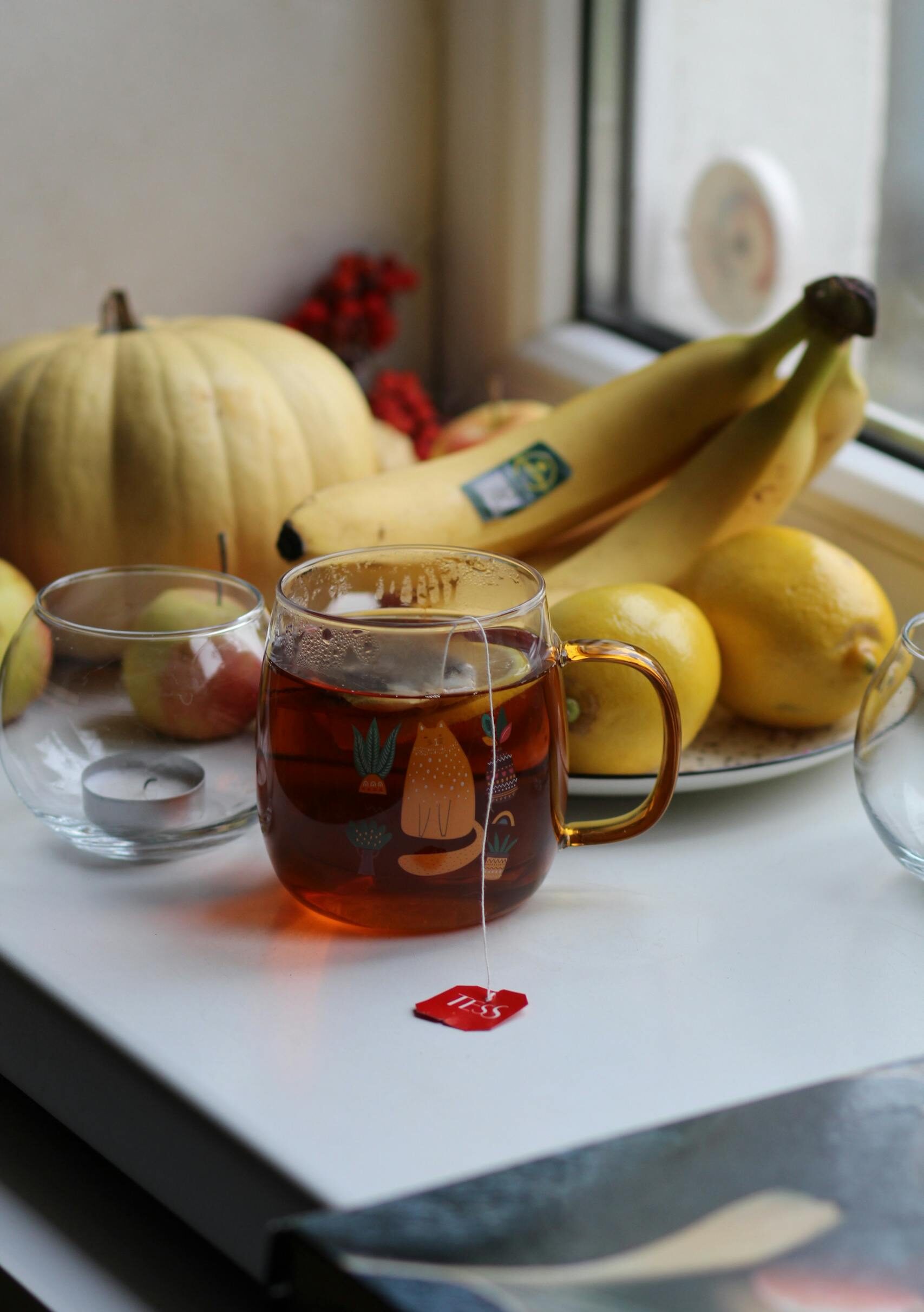 Soft morning light with warm cup of tea with bananas and lemons— calming minerals for mood and energy.