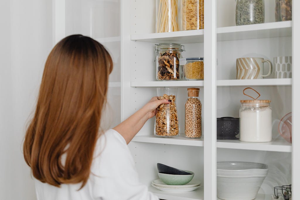 Minimalist pantry with organized jars and baskets for easy cooking.