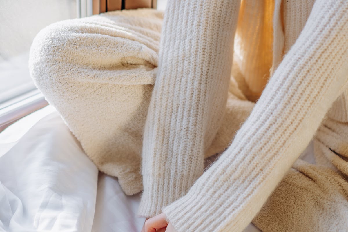close-up of relaxed hands on knees during a gentle breathing moment for calm