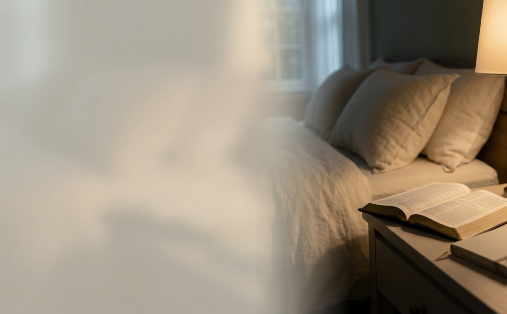 Warm bedside table with glowing lamp, open Bible, journal, and moonlit bedroom atmosphere representing peaceful evening prayer.